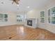 Spacious living room with hardwood floors, fireplace, and plantation shutters at 10115 Day Lily Ct, Bradenton, FL 34212