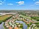 Aerial view of luxury homes surrounding a golf course and waterways at 10115 Day Lily Ct, Bradenton, FL 34212