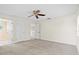 Spacious bedroom with ceiling fan and plush carpeting at 10115 Day Lily Ct, Bradenton, FL 34212