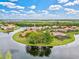 Waterfront community with homes surrounding a lake and fountain at 10115 Day Lily Ct, Bradenton, FL 34212