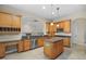 Kitchen with granite countertops, island, stainless steel appliances, and wood cabinets at 10115 Day Lily Ct, Bradenton, FL 34212