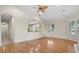 Open living area with hardwood floors, kitchen views and access to the hallway at 10115 Day Lily Ct, Bradenton, FL 34212