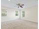 Spacious bedroom with three windows and ceiling fan at 10115 Day Lily Ct, Bradenton, FL 34212