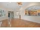 Open living room with hardwood floors, kitchen views, and access to backyard at 10115 Day Lily Ct, Bradenton, FL 34212