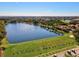 Aerial view of golf course, lake, and community at 10115 Day Lily Ct, Bradenton, FL 34212