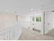 Upstairs hallway with carpeted floors and white railings at 10115 Day Lily Ct, Bradenton, FL 34212