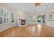 Living room with hardwood floors, fireplace, plantation shutters and sliding doors to patio at 10115 Day Lily Ct, Bradenton, FL 34212