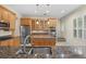 Modern kitchen with granite countertops, stainless steel appliances, and wood cabinets at 10115 Day Lily Ct, Bradenton, FL 34212