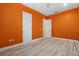 Bedroom with orange walls and light wood flooring at 10115 Day Lily Ct, Bradenton, FL 34212