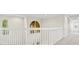 Upstairs hallway with carpeted floor and open railing at 10115 Day Lily Ct, Bradenton, FL 34212