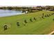 Driving range with golfers practicing their swing at 10115 Day Lily Ct, Bradenton, FL 34212