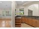 Wet bar with granite countertop and wooden cabinetry at 10115 Day Lily Ct, Bradenton, FL 34212