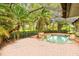 Relaxing screened pool and spa area, surrounded by tropical plants at 10115 Day Lily Ct, Bradenton, FL 34212