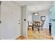 Small dining area with glass-top table and four chairs at 6157 Midnight Pass Rd # E24, Sarasota, FL 34242