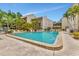 Community pool with surrounding patio and lounge chairs at 6157 Midnight Pass Rd # E24, Sarasota, FL 34242