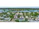 Aerial view of condo building, tennis court, and parking at 6157 Midnight Pass Rd # E24, Sarasota, FL 34242