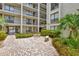 Brick paved courtyard with seating and tropical landscaping at 6157 Midnight Pass Rd # E24, Sarasota, FL 34242