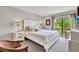 Main bedroom with a king-size bed and large window at 6157 Midnight Pass Rd # E24, Sarasota, FL 34242