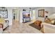 Living room with leather sofa, large TV, and tiled floors at 6157 Midnight Pass Rd # E24, Sarasota, FL 34242
