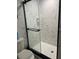 Modern shower with glass enclosure and marble-look tile at 4022 Beaver Ln # 1000G, Port Charlotte, FL 33952