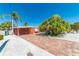 Bright orange house with palm trees and a brick driveway at 2109 Avenue B, Bradenton Beach, FL 34217