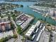 An aerial shot showcases a waterfront community with boat docks, lush landscaping, and stunning views at 220 Santa Maria St # 240, Venice, FL 34285