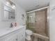 The bathroom has a white vanity with white sink and a glass shower with beige tiling at 220 Santa Maria St # 240, Venice, FL 34285