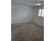 Cozy bedroom with neutral carpeting, white walls, a ceiling fan and a bright window at 220 Santa Maria St # 240, Venice, FL 34285