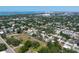 Wide aerial shot of a modern home featuring a pool, circled for emphasis, in a lush neighborhood setting with a cityscape afar at 2226 Grove St, Sarasota, FL 34239