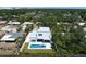 Aerial shot featuring a modern home with a pool in a leafy neighborhood, creating a serene and private oasis at 2226 Grove St, Sarasota, FL 34239