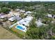 Aerial view showcasing a modern home with a pool, surrounded by mature trees in a quiet, residential neighborhood at 2226 Grove St, Sarasota, FL 34239