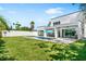 Spacious backyard with lush green lawn, modern white fence, and inviting pool area for outdoor relaxation and entertainment at 2226 Grove St, Sarasota, FL 34239