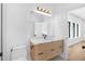 Modern bathroom featuring a wood vanity, a large mirror and modern lighting at 2226 Grove St, Sarasota, FL 34239