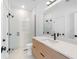 Modern bathroom featuring a glass shower, sleek vanity with a white countertop and black hardware accents at 2226 Grove St, Sarasota, FL 34239