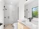 Modern bathroom featuring a glass shower, floating vanity, and a window that offers plenty of natural light at 2226 Grove St, Sarasota, FL 34239