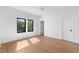 Bright bedroom with hardwood floors and black framed windows, offering an abundance of natural light at 2226 Grove St, Sarasota, FL 34239