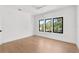 Bright bedroom with hardwood floors and three large windows, offering an abundance of natural light at 2226 Grove St, Sarasota, FL 34239