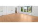 Bedroom features natural light, hardwood floors, and a view of the neighborhood through black framed windows at 2226 Grove St, Sarasota, FL 34239