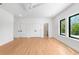 Spacious bedroom with hardwood floors, closet doors, and backyard view through black framed windows at 2226 Grove St, Sarasota, FL 34239