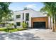 Striking modern home featuring clean lines, wood accents, and a sleek, glass-door garage at 2226 Grove St, Sarasota, FL 34239