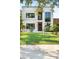 Striking modern two-story home with a well-manicured front yard, lush landscaping, and contemporary architectural details at 2226 Grove St, Sarasota, FL 34239