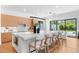 Bright, modern kitchen with an oversized island, wood cabinetry, and pool views at 2226 Grove St, Sarasota, FL 34239