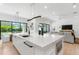 Open-concept kitchen island features a sink, microwave, and breakfast bar overlooking the living area at 2226 Grove St, Sarasota, FL 34239