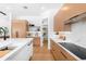 Modern kitchen boasts wood cabinetry, marble counters, and a walk-in pantry for ample storage at 2226 Grove St, Sarasota, FL 34239