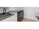 Laundry room area with countertop, sink, modern washer and dryer units at 2226 Grove St, Sarasota, FL 34239