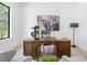 Comfortable home office with a sleek wooden desk, soft armchairs, and stylish decor at 2226 Grove St, Sarasota, FL 34239