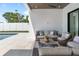 Outdoor patio featuring comfortable wicker seating around a stone tiled area with a pool in the background at 2226 Grove St, Sarasota, FL 34239