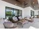 Outdoor living space with wicker seating, decorative pillows, and a pool view, great for entertaining at 2226 Grove St, Sarasota, FL 34239