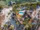 Drone shot showing the house's layout, pool, and proximity to the water at 7147 La Lenaire Dr, Longboat Key, FL 34228