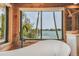 Bathroom with a freestanding tub and large window with water views at 7147 La Lenaire Dr, Longboat Key, FL 34228